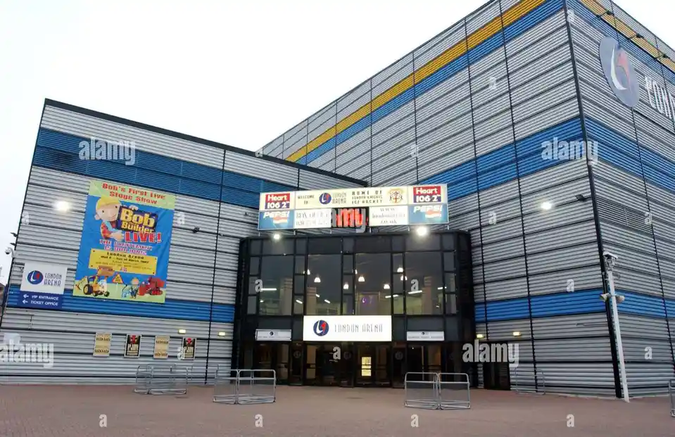 The exterior of the London Arena, a modern building with blue and silver paneling, features a large banner advertising 'Bob…