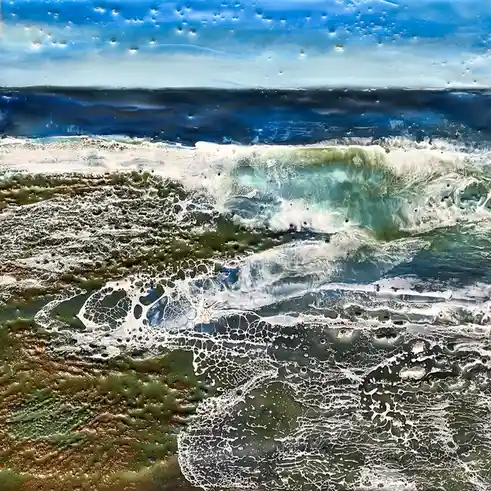 An abstract painting of ocean waves with blue sky, dark water, and foamy white surf crashing onto a greenish shore. The…