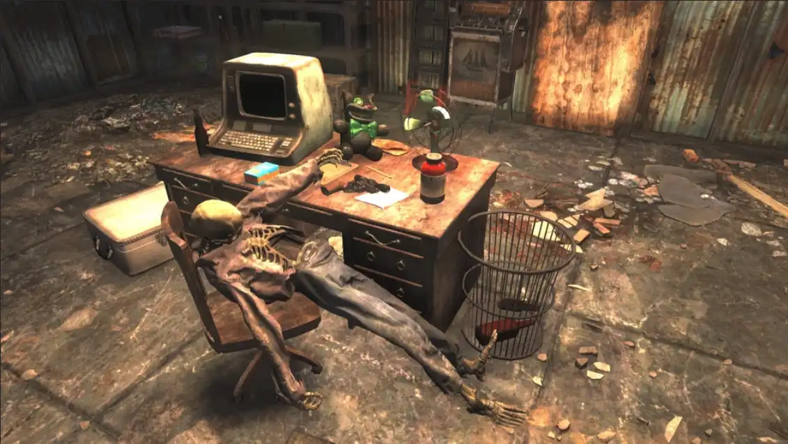A skeleton is slumped over a chair in front of a cluttered, dusty desk in a ruined room, with a vintage computer, a fan, and…