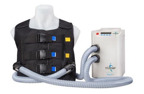 A white mannequin torso wears a black vest with blue and yellow square patches, connected by gray tubes to a white machine…