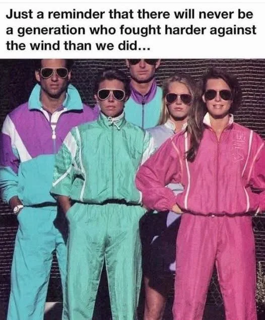 A group of five people, likely from the 1980s, pose confidently in brightly colored, form-fitting tracksuits with matching…