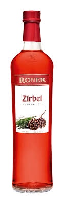 A clear glass bottle of Roner Zirbel liqueur, filled with a bright red liquid, has a white label with the brand name 'Roner'…
