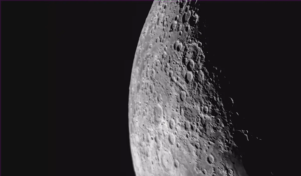 A black-and-white image shows a close-up of the moon's cratered surface against a dark background, with the text 'i'm not…