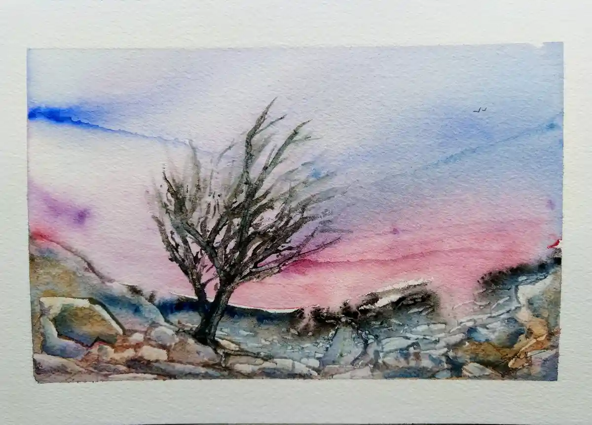 A watercolor painting depicts a solitary, leafless tree standing on rocky terrain against a sky painted with soft gradients…