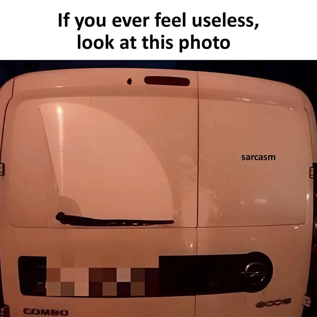 The image shows the rear of a white Opel Combo van, with the word 'sarcasm' written in black text on the right side of the…