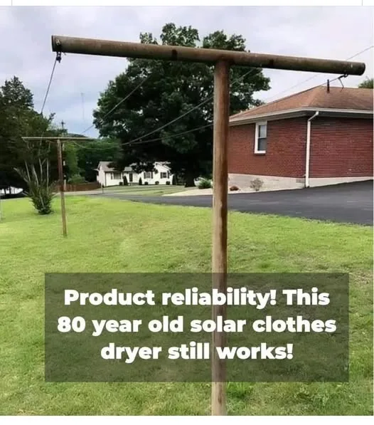 An outdoor photo shows a simple wooden clothesline structure with horizontal poles and wires, set in a grassy yard in front…