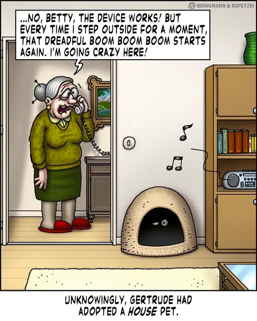 An elderly woman with grey hair in a bun, wearing a green sweater and skirt, stands in a doorway holding a phone to her ear…