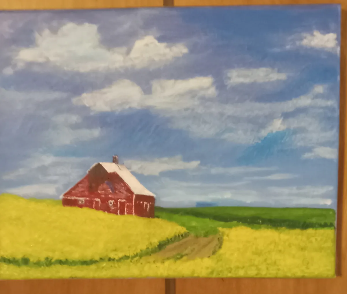 A painting depicts a red barn with a white roof sitting in a field of yellow flowers under a blue sky with white clouds. The…