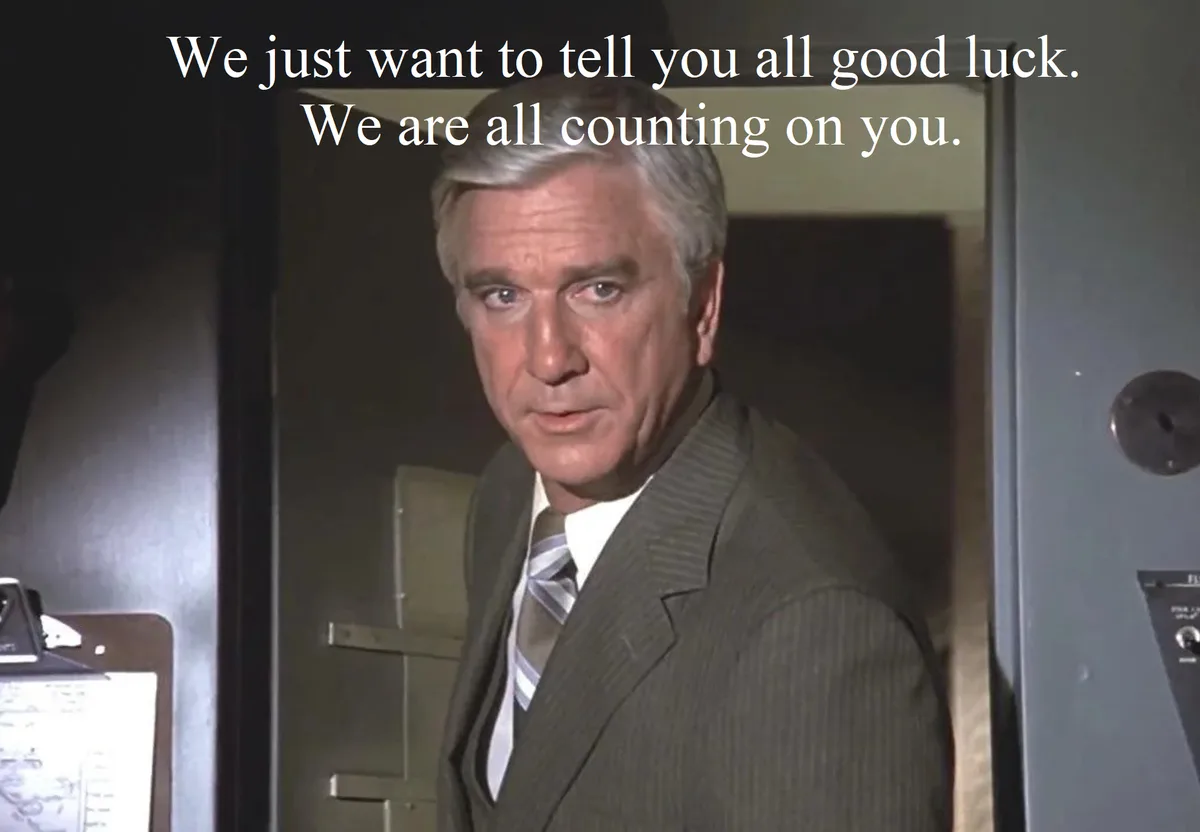 A still image of a man in a suit and tie, looking serious and intense, with overlaid white text reading 'We just want to…