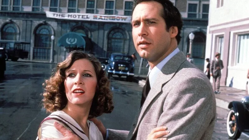 A still from the 1980 film 'The Hotel New Hampshire' shows a man and woman standing outside a building labeled 'THE HOTEL…