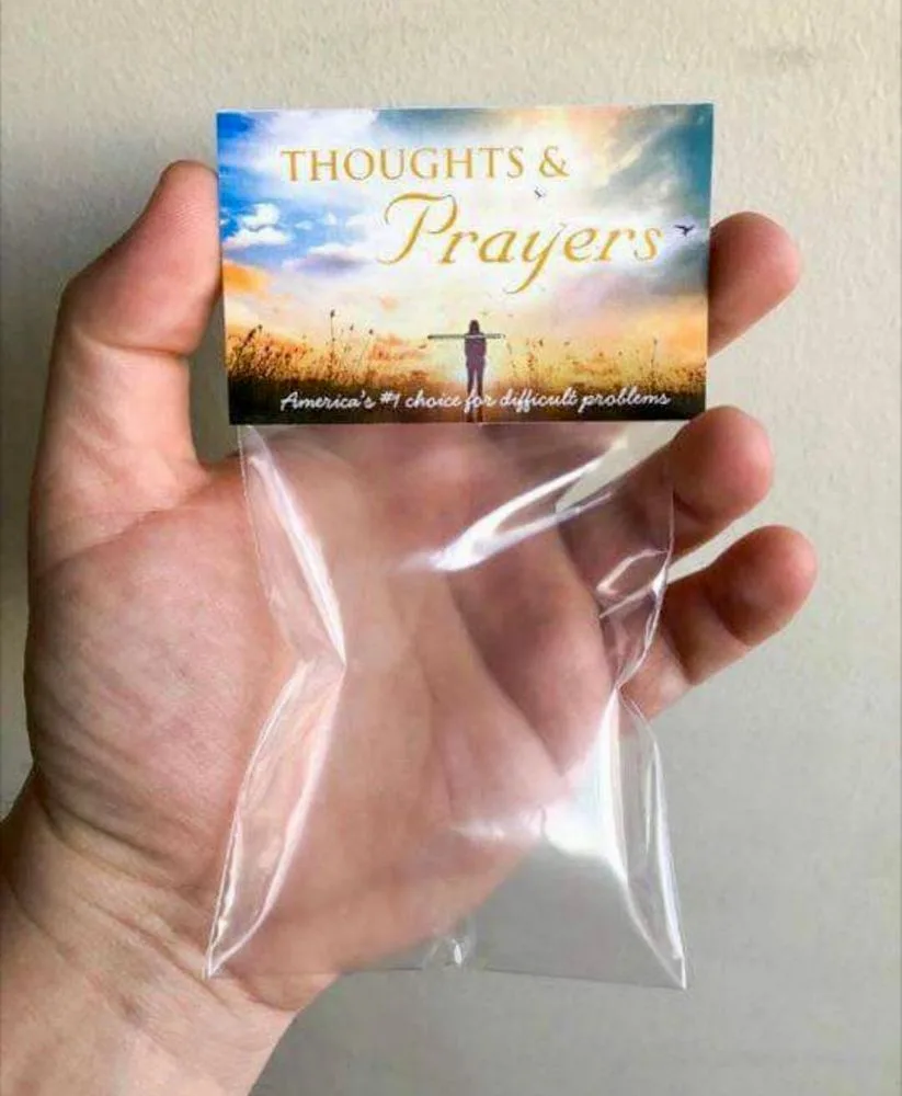 A hand holds a clear plastic bag containing a small card with a sunset image and text. The card reads 'THOUGHTS & Prayers'…