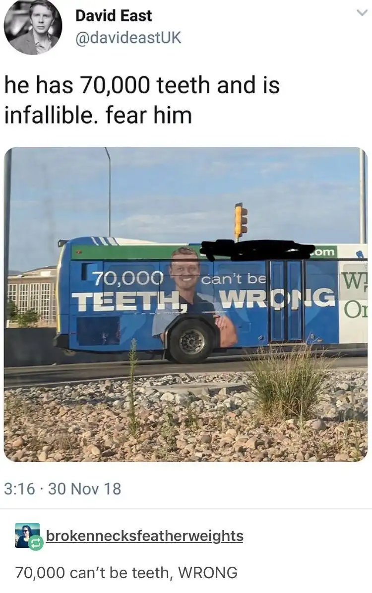 A blue bus has an advertisement featuring a smiling man with the text '70,000 TEETH, can't be WRONG' overlaid on his image…