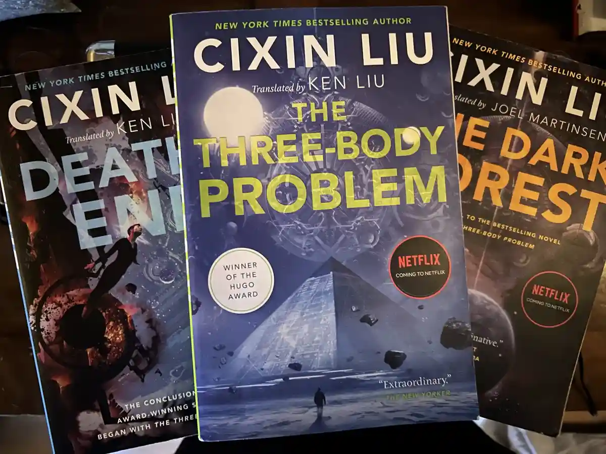 Three books from Cixin Liu's 'Three-Body' trilogy are shown side by side, with 'The Three-Body Problem' in the center…