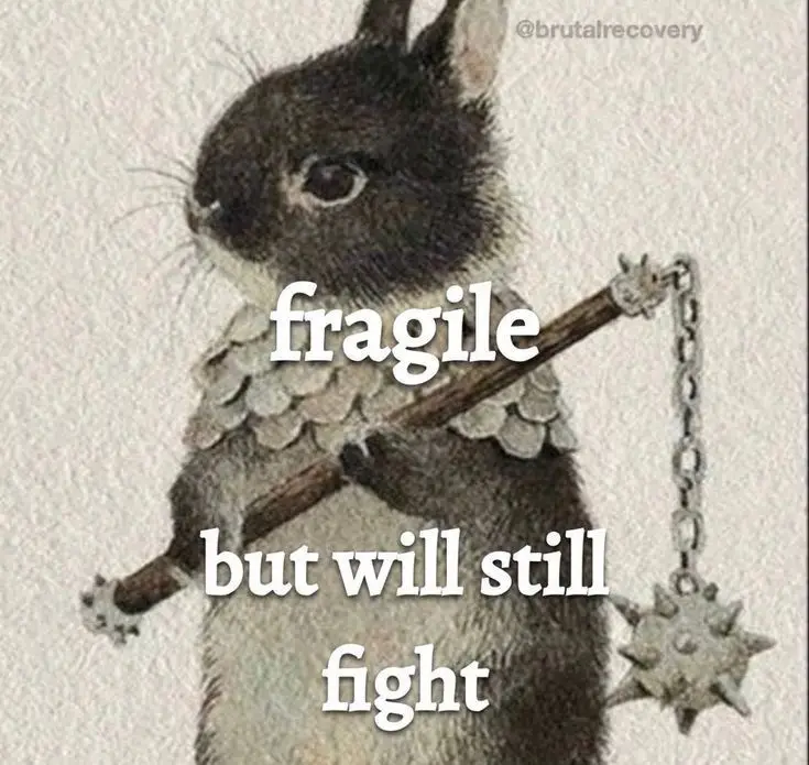 A drawing of a small, dark-furred rabbit wearing a scale-like armor and holding a spiked mace with a chain. White text…