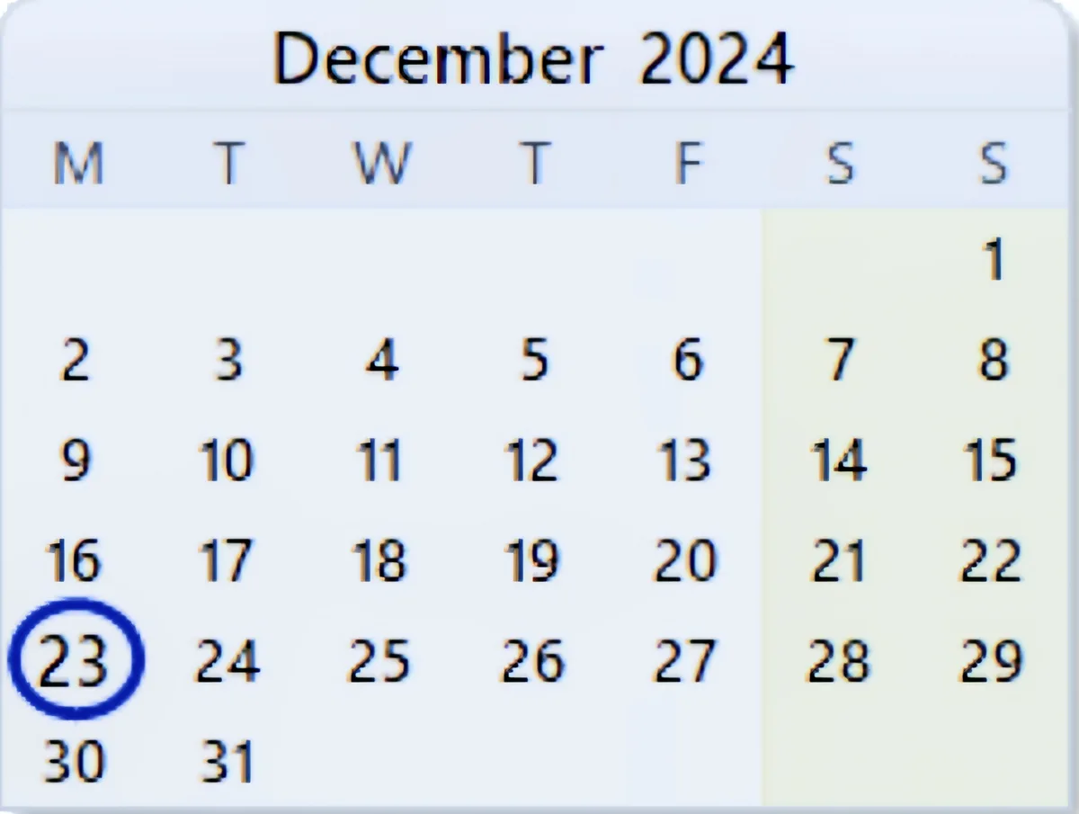A digital calendar for December 2024 shows the days of the week with the 23rd circled in blue, indicating a specific date…