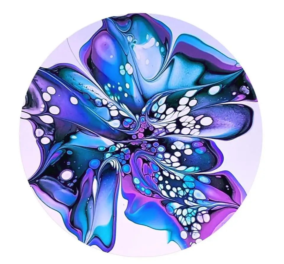 A circular abstract painting resembling a flower with swirling blue, purple, and white paint. The petals have glossy…