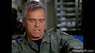 A six-frame GIF shows a man in a green military-style jacket, initially looking annoyed or disgusted, then his expression…