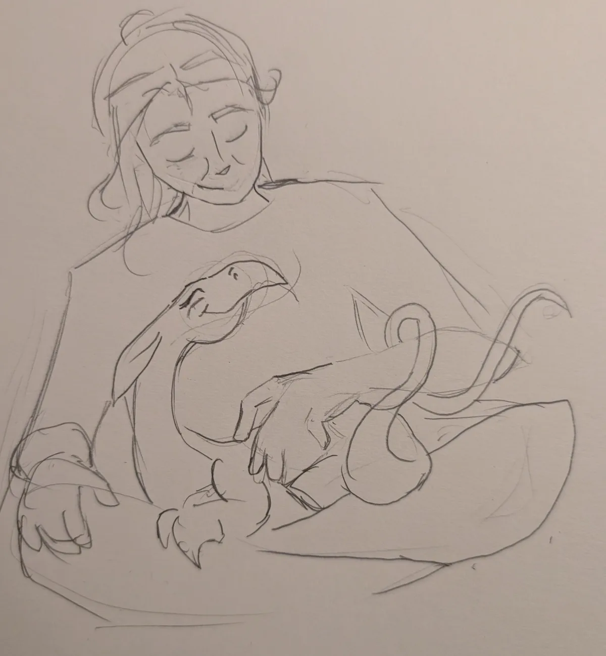 A pencil sketch shows a person with closed eyes and a serene smile, cradling a small, dragon-like creature with wings and a…