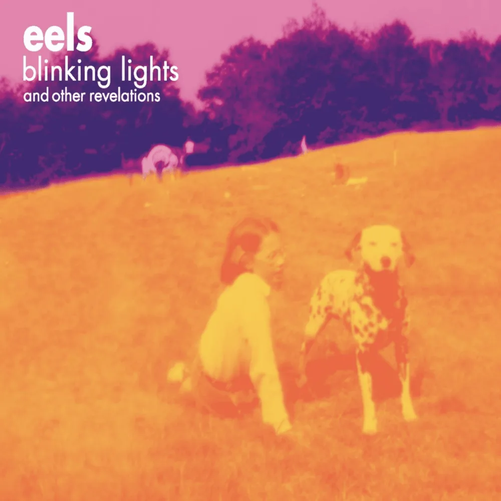 The image is the album cover for 'Blinking Lights and Other Revelations' by the band Eels, featuring a vintage photo of a…