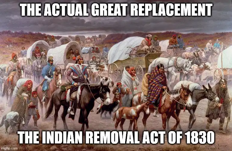 A historical painting depicts a large group of Native Americans, many on horseback and pulling covered wagons, moving across…