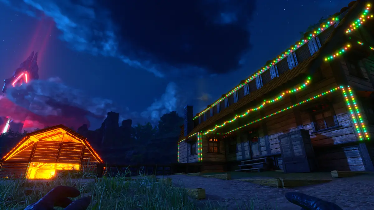 A nighttime scene from a video game shows two wooden cabins decorated with bright, colorful string lights against a dark…