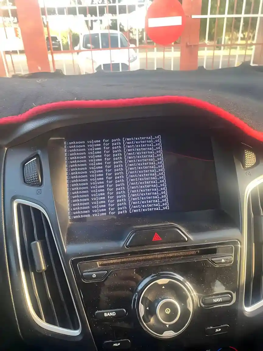 A car's infotainment screen displays a repeating Linux error message 'E: unknown volume for path [/mnt/external_sd]' instead…