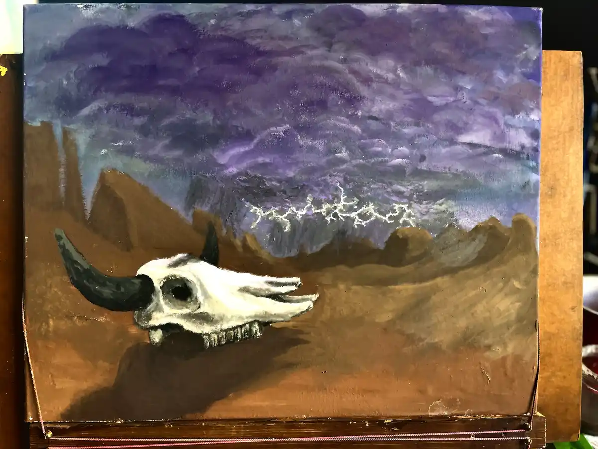 A painting depicts a white bull skull with black horns resting on brown earth under a dramatic purple sky with white…