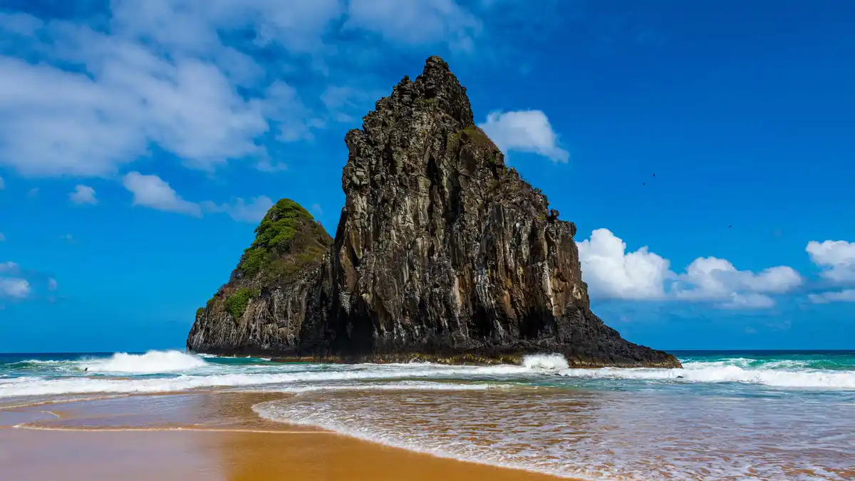 Two Brothers Rock, a distinctive duo of volcanic sea stacks, stands out against the backdrop of the remote Fernando de…