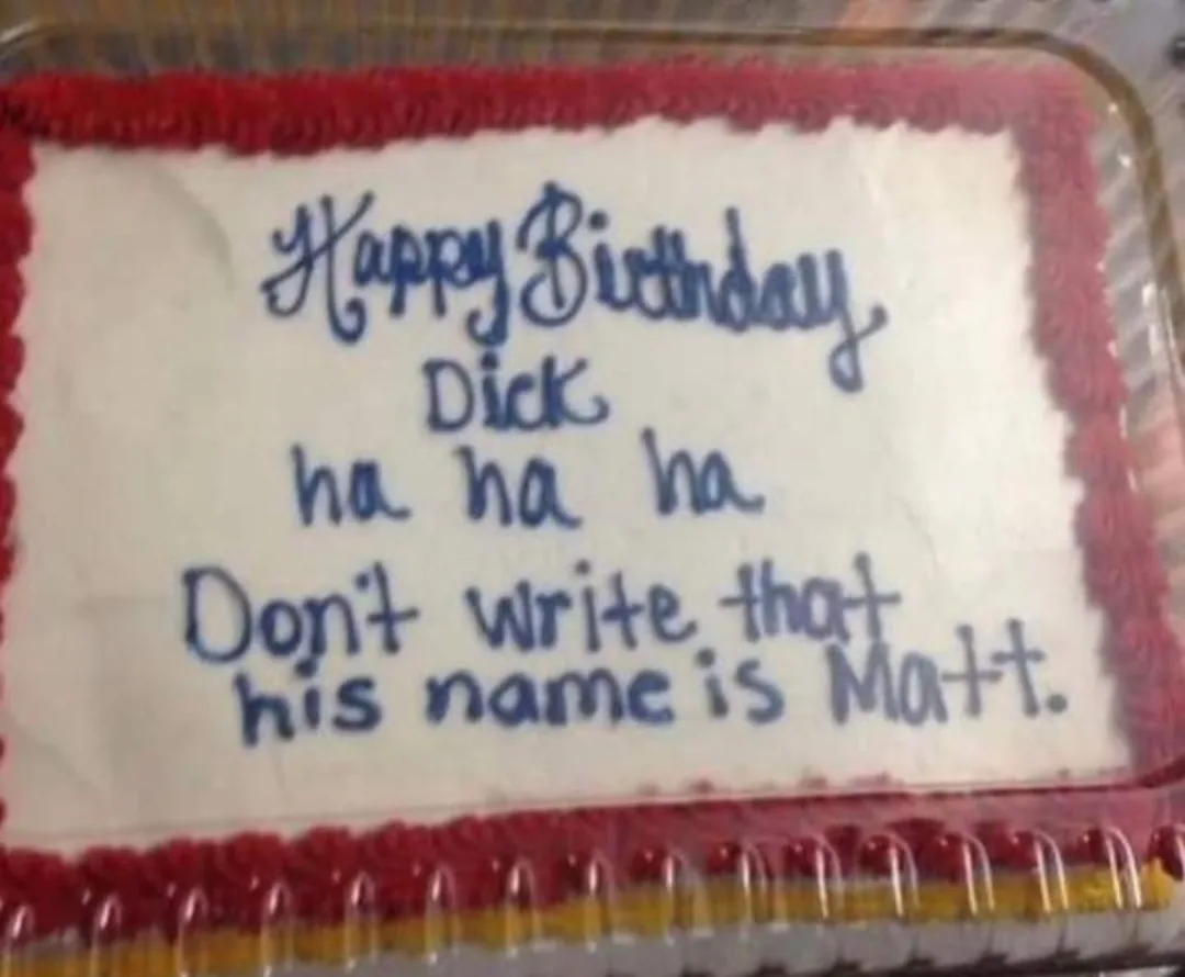 A rectangular birthday cake with white frosting and red piped border has blue icing text that reads 'Happy Birthday Dick ha…