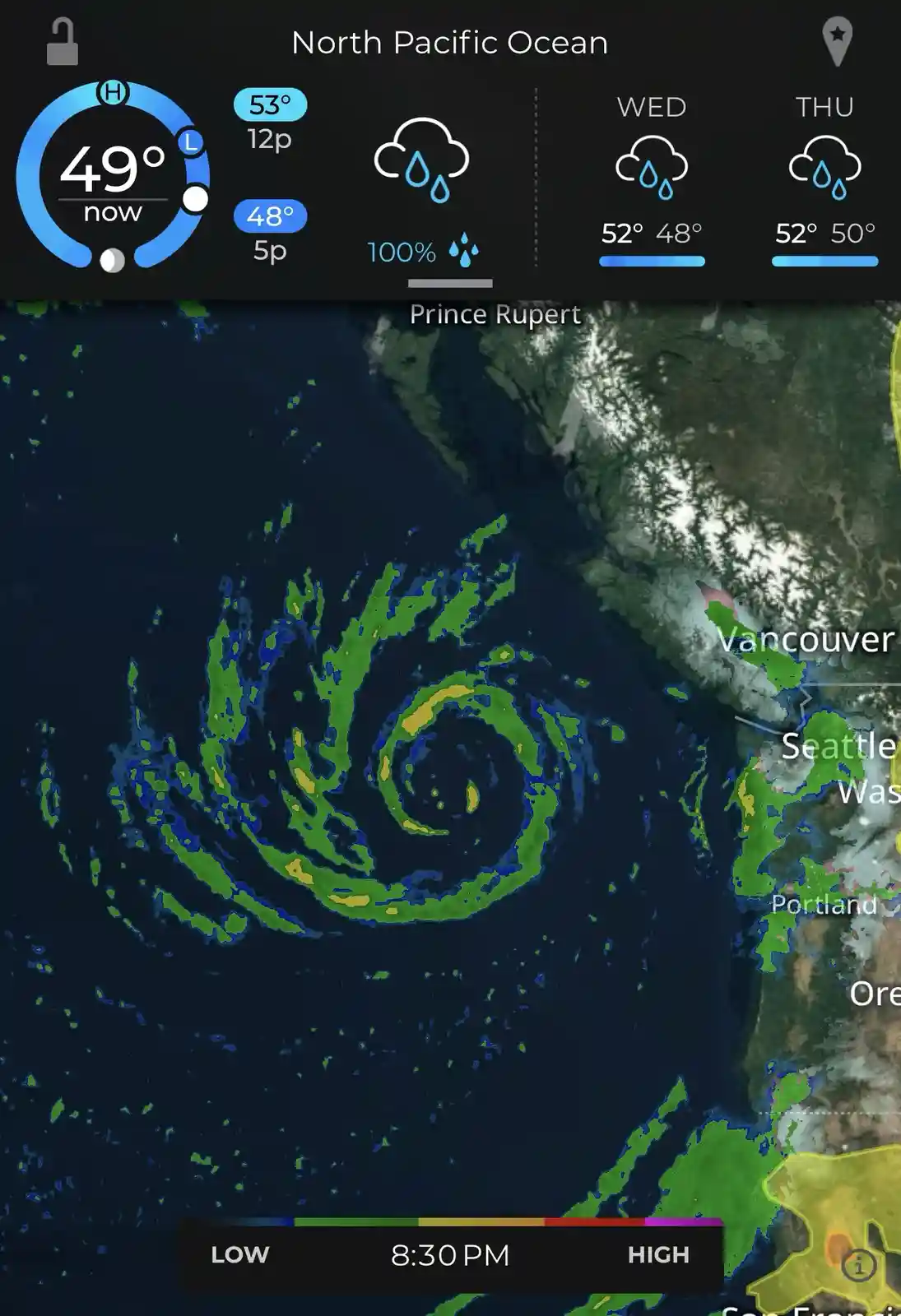 A weather app screenshot shows a swirling green and yellow radar pattern over the North Pacific Ocean, with cities like…