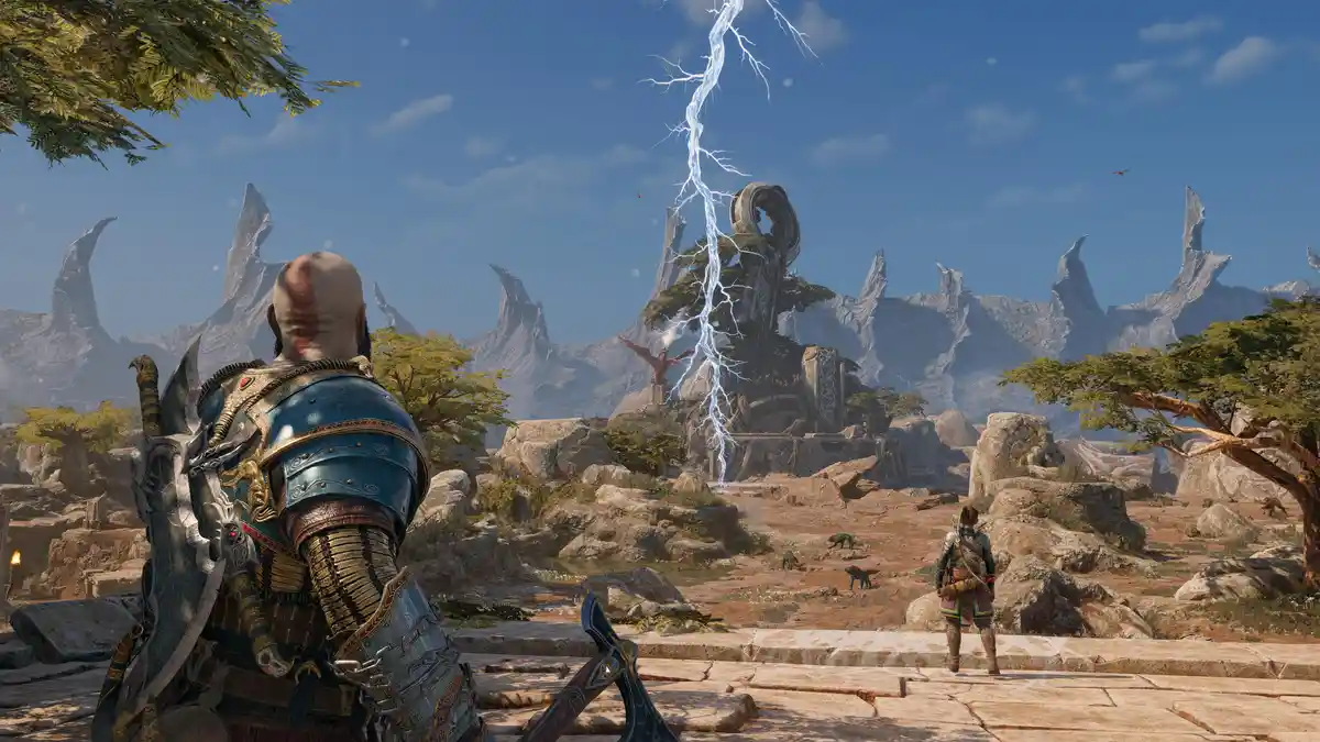 A screenshot from the video game God of War shows the protagonist Kratos, viewed from behind, standing on stone steps in a…