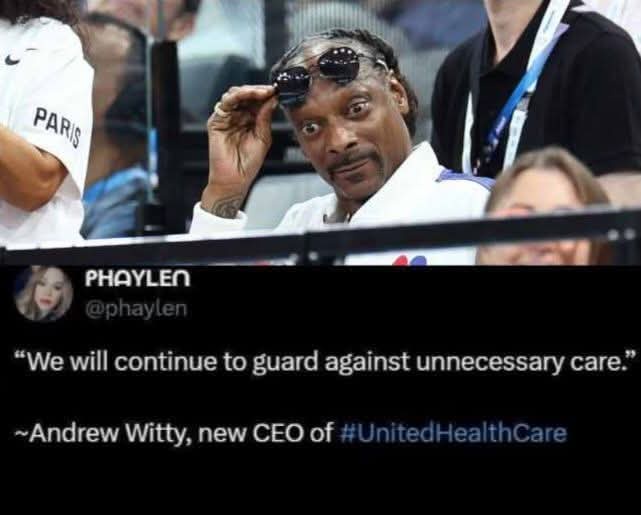 A photo of Snoop Dogg at a basketball game, holding his sunglasses up to his forehead with a skeptical, unimpressed…