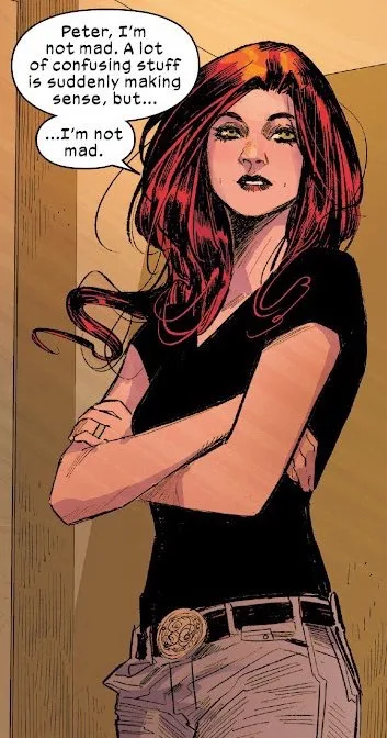 A comic book panel shows a woman with red hair and green eyes, arms crossed, wearing a black top and jeans with a belt…