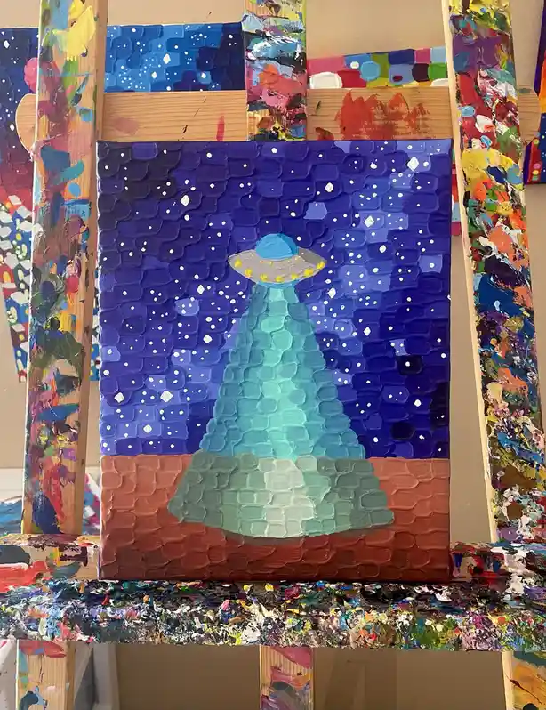 A textured, thickly painted canvas depicts a classic flying saucer UFO emitting a bright, conical beam of light that…