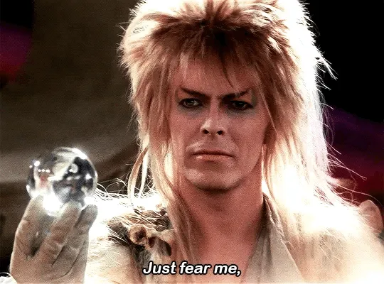 A six-panel image strip shows David Bowie as the Goblin King from Labyrinth, holding a crystal ball in each frame. He has…