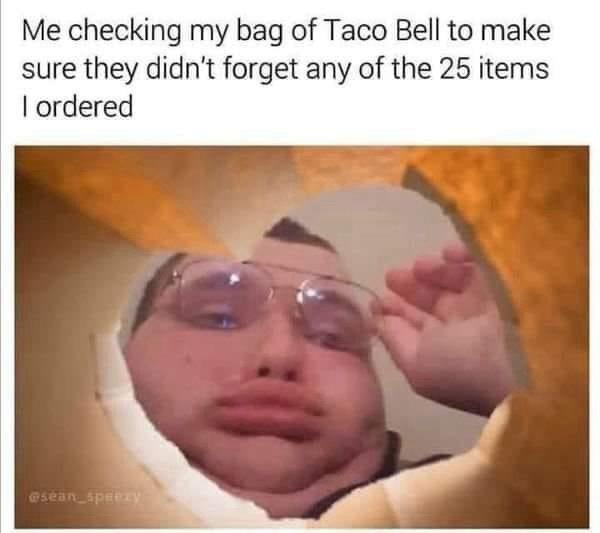 A person with glasses peers out from inside a large, golden-brown, taco-shaped object, looking intensely at the viewer…