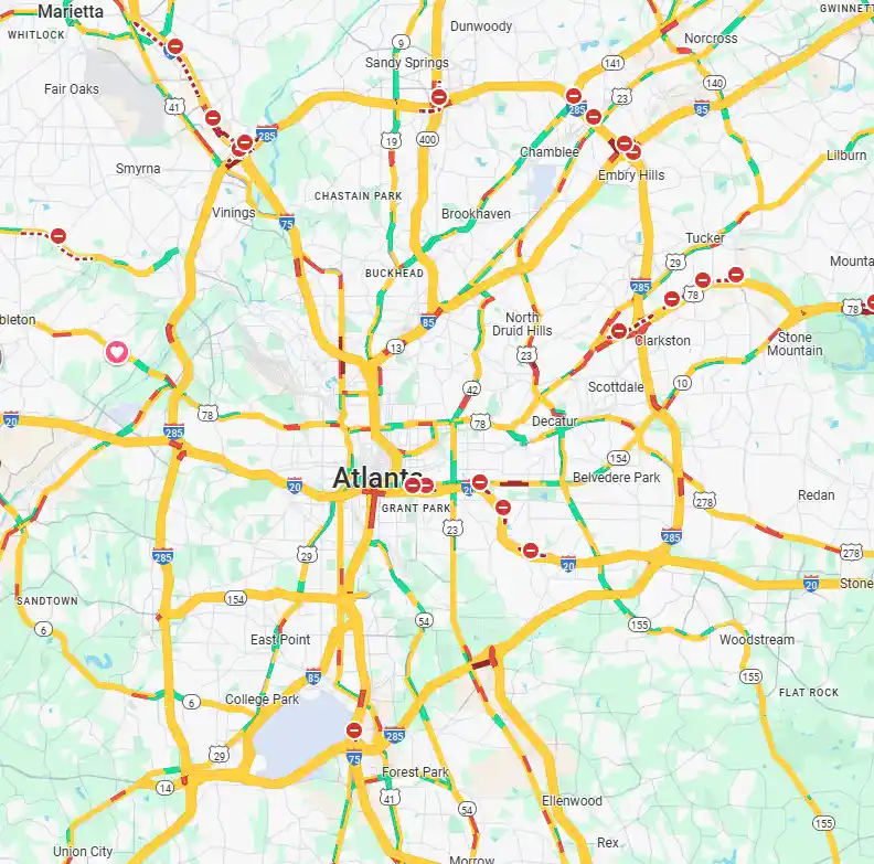 A map of Atlanta showing numerous highways and roads, all heavily congested with red and orange traffic indicators, visually…