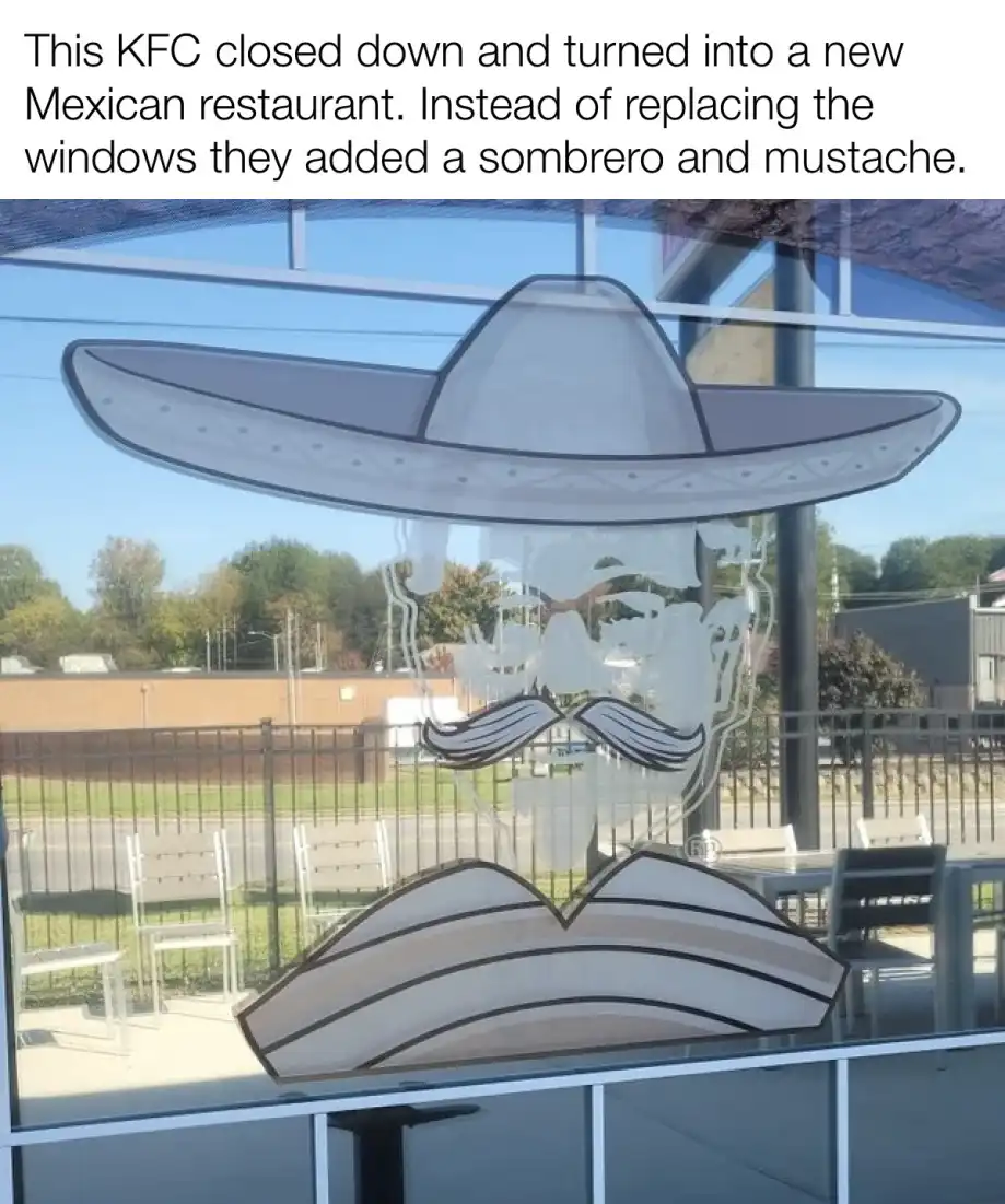 A photo shows a restaurant window with a large, cartoonish sombrero and mustache decal applied over it. The background…