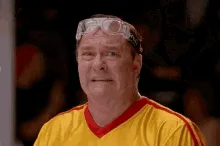 A six-panel image sequence shows a man in a yellow and red sports jersey with clear protective goggles on his head. He…