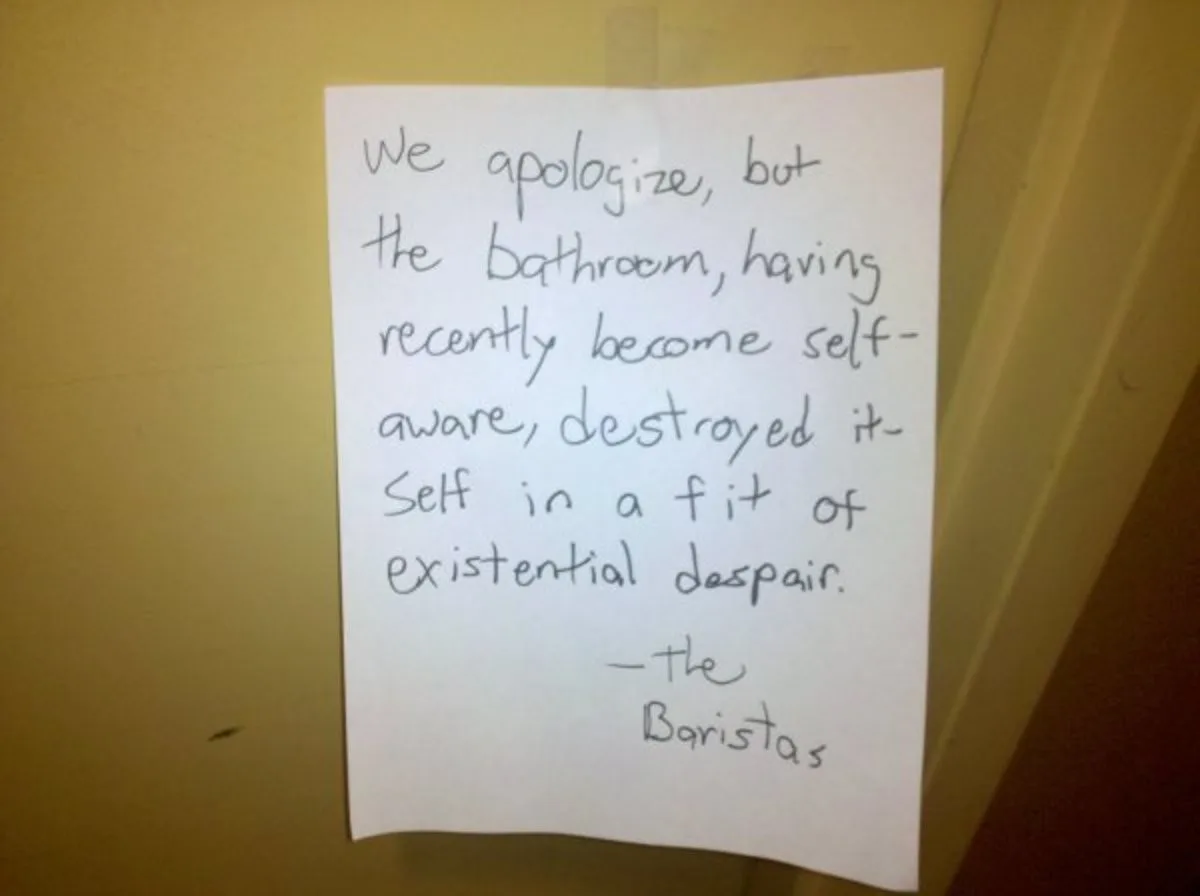 A handwritten note on white paper taped to a yellow wall, humorously explaining that the bathroom destroyed itself due to…