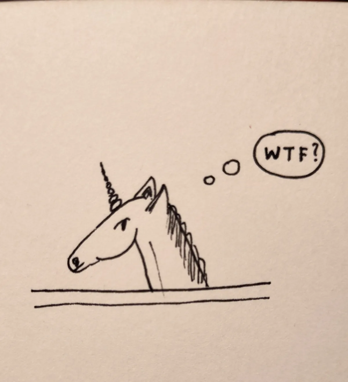 A simple black-and-white line drawing shows the head and neck of a unicorn emerging from behind a horizontal line, as if…