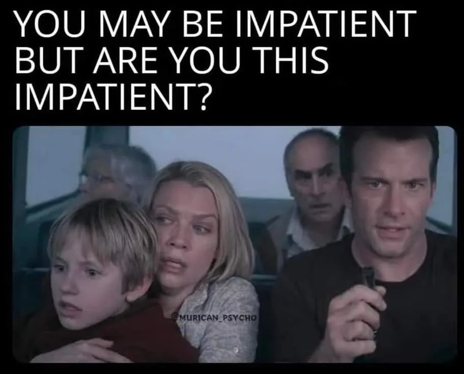 A still from a movie shows a man holding a small object, looking intensely at the camera, with a woman and child beside him…