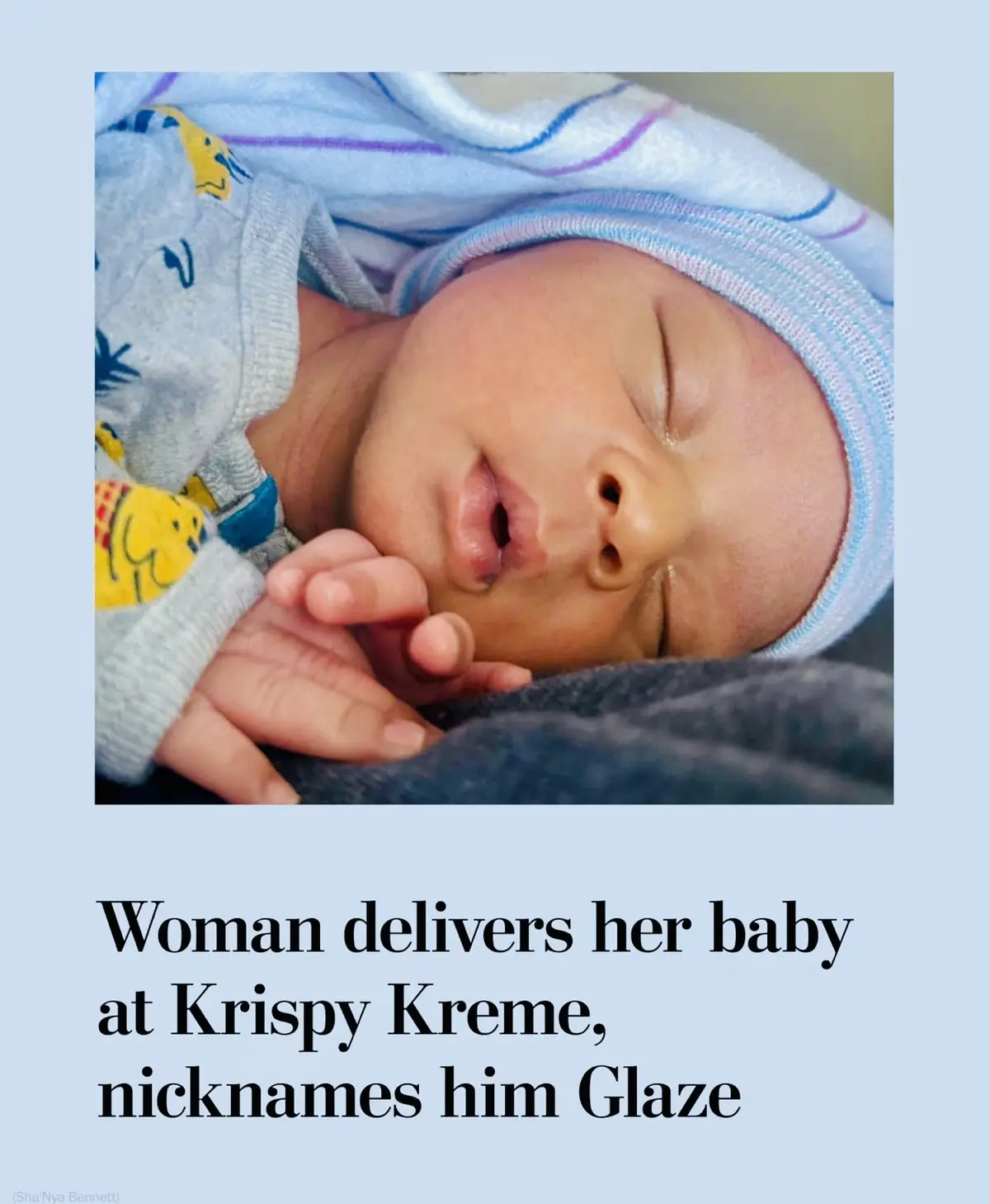 A close-up photo shows a sleeping newborn baby wrapped in a light blue and white striped blanket, wearing a matching hat and…