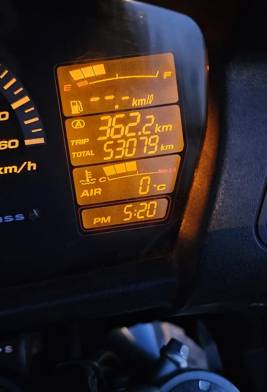 A close-up of a motorcycle's digital dashboard showing a trip odometer reading 362.2 km and a total odometer reading 53079…