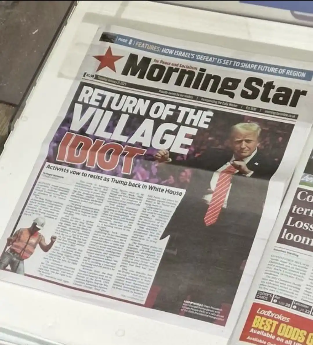 A close-up photo of a newspaper titled 'Morning Star' with a large headline reading 'RETURN OF THE VILLAGE IDIOT' over a…