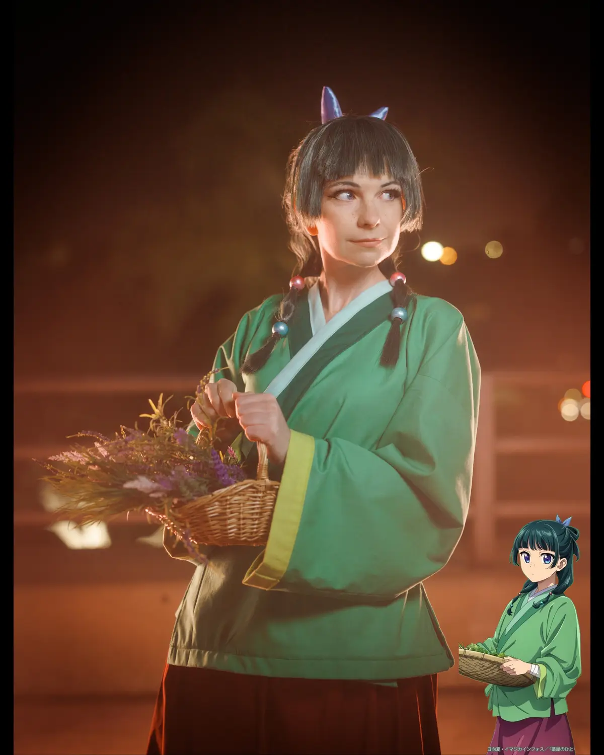 A cosplayer in a green traditional outfit with purple cat ears and braided hair holds a basket of purple flowers, looking…