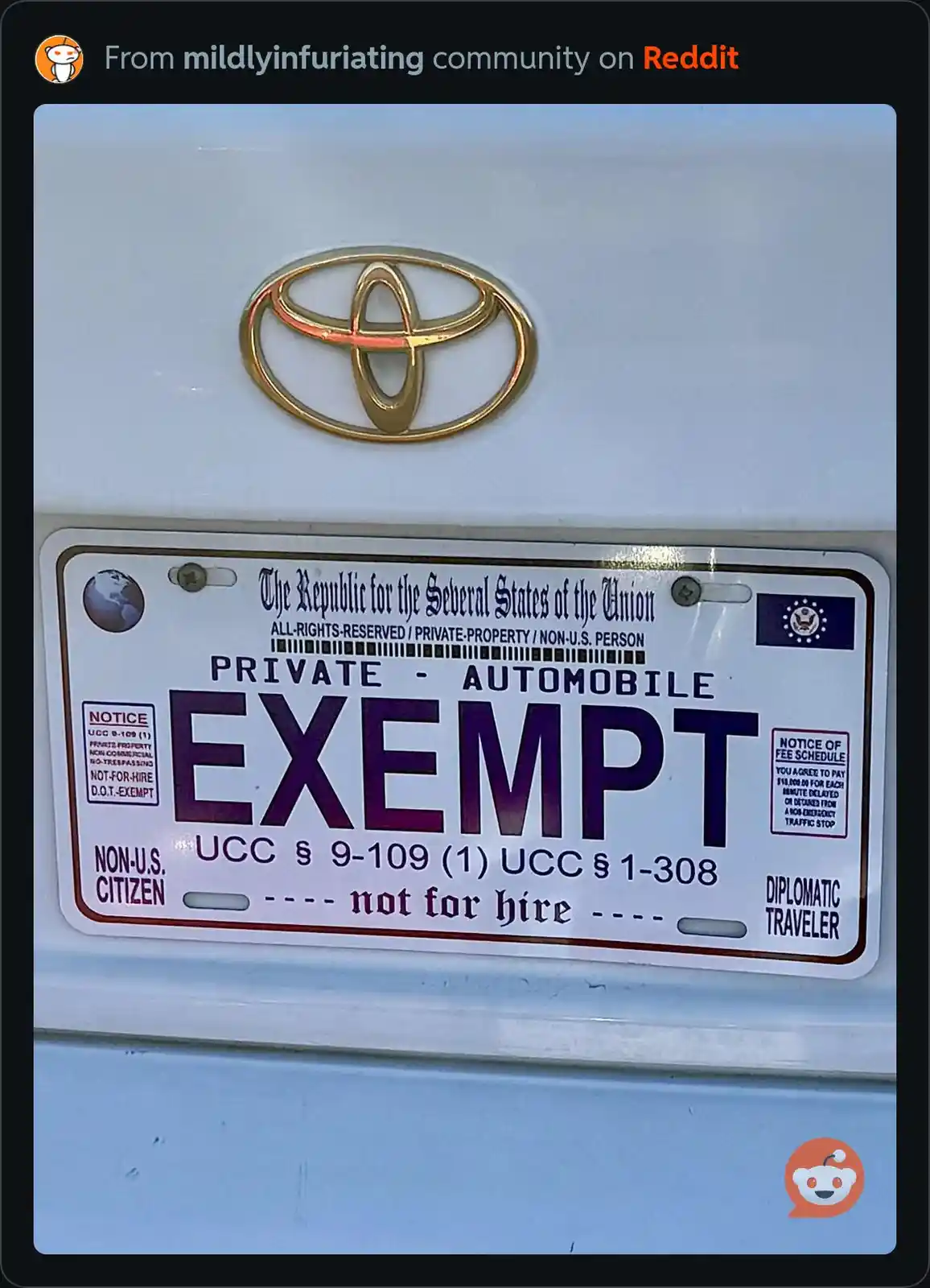 A close-up photo shows a white Toyota vehicle's rear license plate, which reads 'EXEMPT' in large purple letters. The plate…