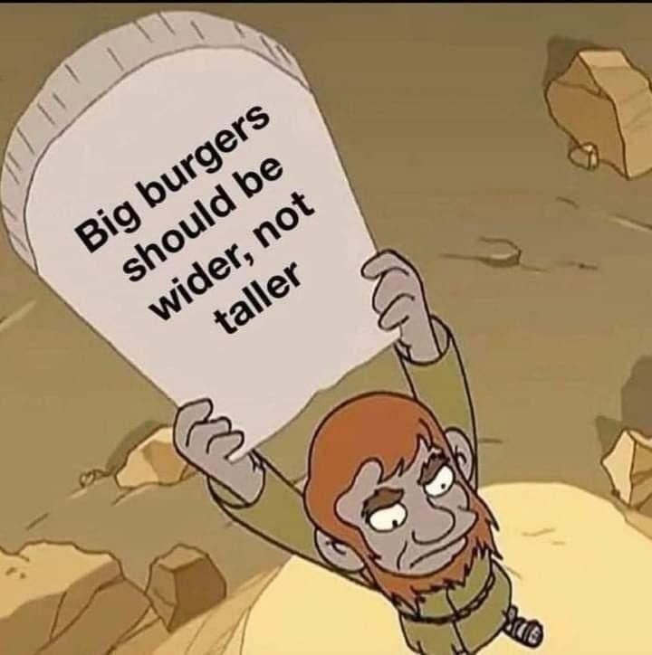 A cartoon caveman with a worried expression holds up a large, flat tombstone in a rocky desert. The tombstone has black text…