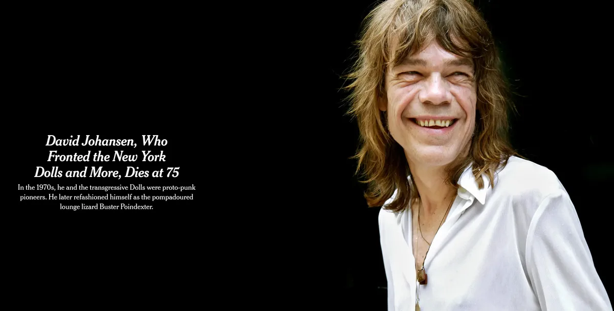 A smiling man with long, wavy brown hair and a white shirt is shown against a black background. Overlaid text reads: 'David…