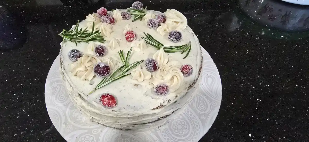 Indulge in This Homemade Spice Cake Topped with Eggnog Frosting and Candied Cranberries!